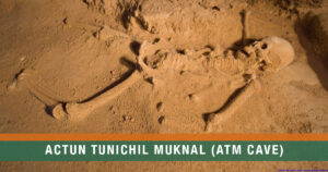 The Crystal Maiden skeleton illuminated by soft cave light inside the Actun Tunichil Muknal Cave in Belize.