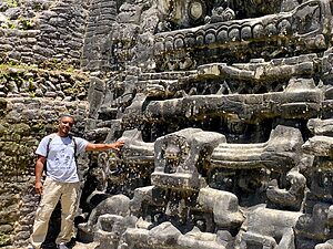 Alvin J. Brown standing beside the Water Lily Serpent carving at Caracol, Belize – July 12, 2025