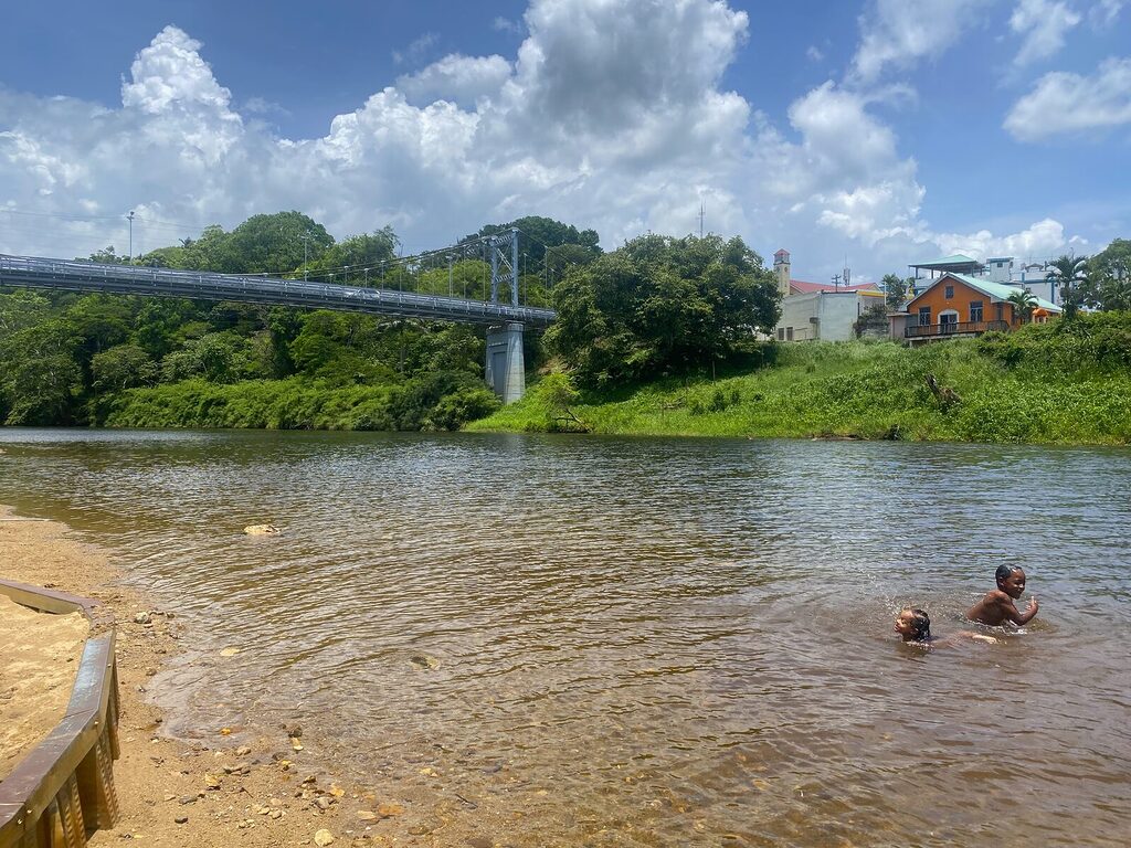 Children swimming in the Macal River under Hawksworth Bridge in San Ignacio, Belize