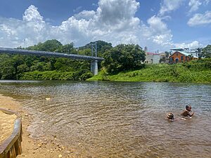 Children swimming in the Macal River under Hawksworth Bridge in San Ignacio, Belize