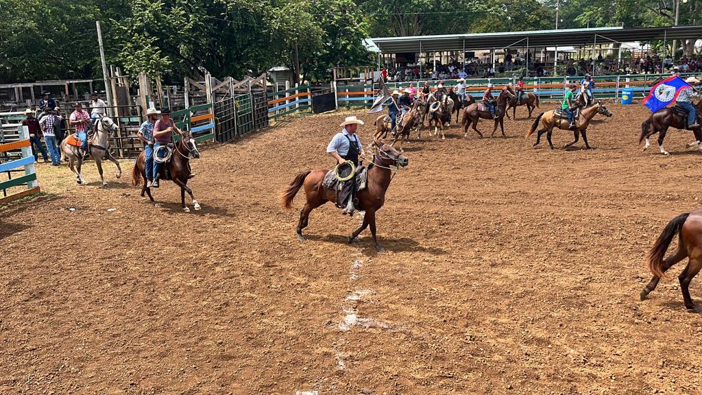 Mennonite rider on horseback in the foreground at the Belize Beef Fest Rodeo 2025 in Belmopan.