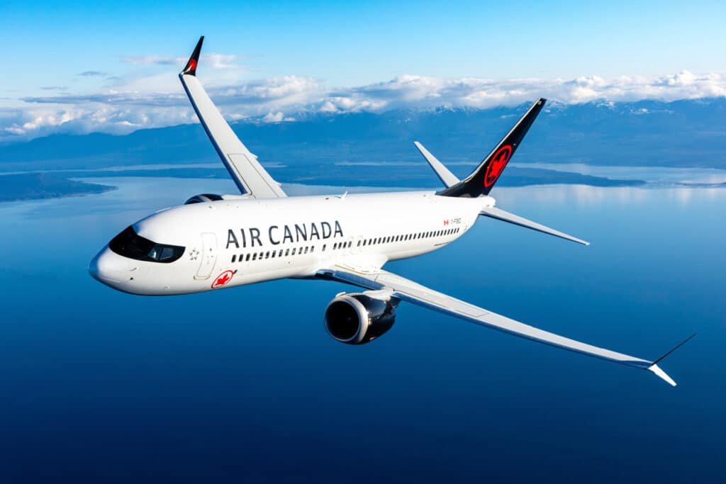 Air Canada Boeing 737 on runway under blue sky, symbolizing new nonstop flights from Montreal, Toronto, and Calgary to Belize