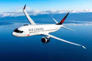 Air Canada Boeing 737 on runway under blue sky, symbolizing new nonstop flights from Montreal, Toronto, and Calgary to Belize